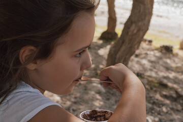Simple summer joy: child enjoying a scoop of ice cream on a sunny day