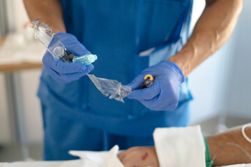 Medical professional preparing iv insert with patient