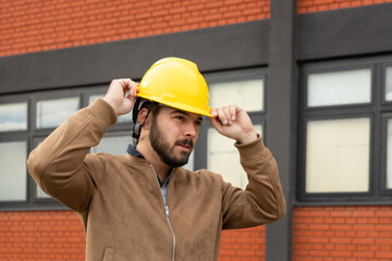 Engineering professional wearing safety hard hat at construction site