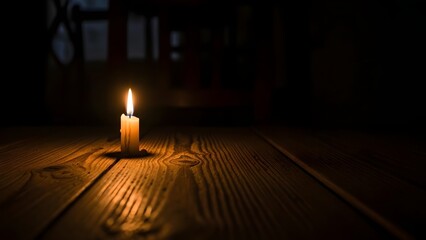 Warm candlelight casting a glow on dark wood, creating a cozy ambiance, A single candle flame illuminates a wooden table in the darkness