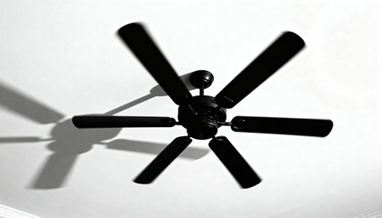 Obraz premium Rotating black ceiling fan silhouette on white ceiling