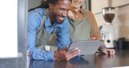 Diverse baristas tapping tablet pointing and scrolling order to prepare coffee at cafe counter - Powered by Adobe