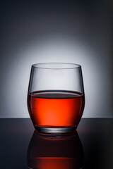 Festive Red Drink in Glass on Dark Background. Holiday Celebration Mood. Christmas Snow Globe Cocktail Concept.