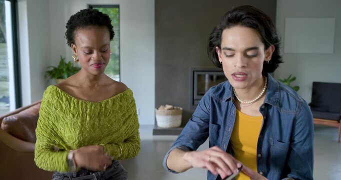 Diverse friends clapping, talking and demonstrating makeup with blush compact and palette at home
