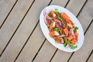Spicy Thai salad with crab sticks and red onion.