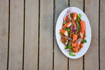 Spicy Thai salad with crab sticks and red onion.