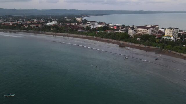 Coastal city view with beach and buildings on a hazy day, raw file, log file