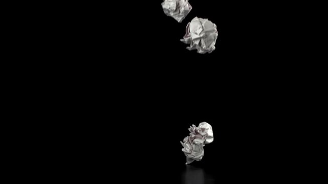 Crumpled paper falls on a black background. Filmed on a high-speed camera at 1000 fps. High quality FullHD footage