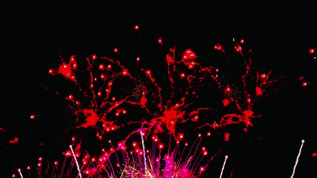  4K. loop seamless of real fireworks background golden shining fireworks with bokeh lights in the night sky. glowing fireworks show. New year's eve fireworks celebration multiple colors