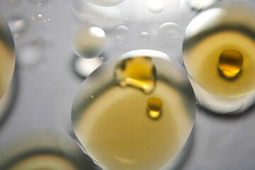 Close-Up of Transparent Droplets with Golden Liquid in Background