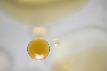 Abstract Water Droplet with Yellow Hue on a Soft Background