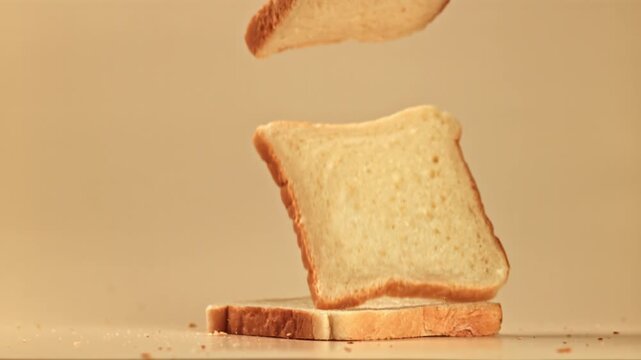 Pieces of bread fall on the table. Filmed on a high-speed camera at 1000 fps. High quality FullHD footage