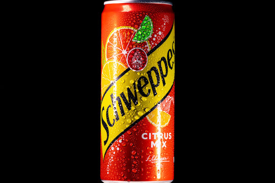 Schweppes Citrus Mix can covered with water drops on a black background
