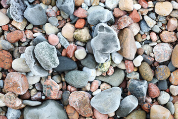 Natural arrangement of pebbles and lichens perfect for design backgrounds, Intricate detail of weathered stones adorned with pale lichen patches and textured surfaces
