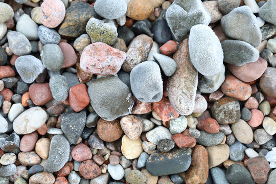 Natural arrangement of pebbles and lichens perfect for design backgrounds, Intricate detail of weathered stones adorned with pale lichen patches and textured surfaces