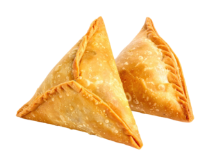 Two crispy, golden-brown triangular pastries isolated against a black background