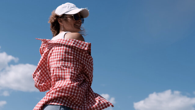 Teen girl eating hamburger outdoors. Fast food concept.