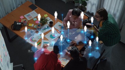 A diverse team collaborates in a modern office space, utilizing data visualization tools and creative resources to enhance project development and communication efforts. Raster