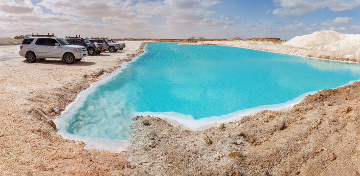 Salt pools in Siwa, Egypt: crystal-clear turquoise water bordered by white salt and desert terrain