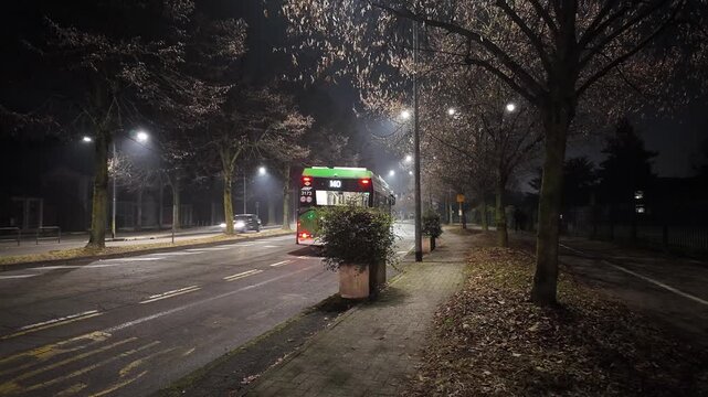 Green Electric Bus Departing from Urban Transit Stop