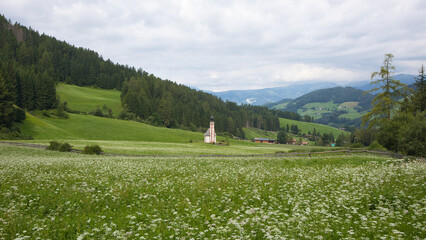 Landscape with the small church of San Giovanni in the Funes Valley in the heart of the Dolomites in South Tyrol.