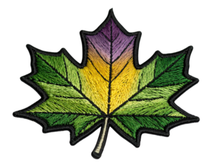 Embroidered maple leaf patch showing vibrant green, yellow, and purple colors on black background