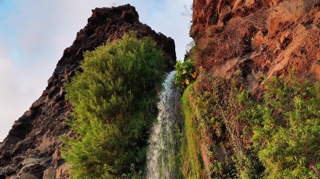 Witness the Natural Beauty of Cascata dos Anjos Waterfall Cutting Through Dramatic Cliffs in Madeira Portugal