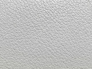 close-up of white pebbled leather texture with detailed fine grain and soft bumpy surface in light...