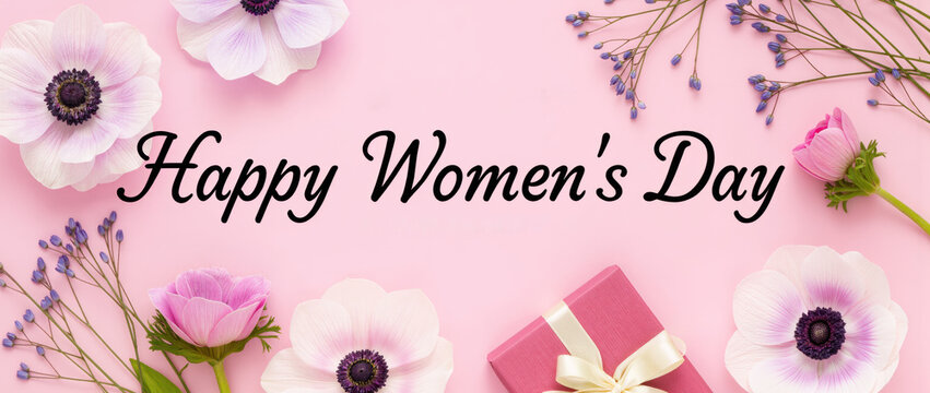 Happy Women's Day celebration with pink gift box and fresh flowers on background. Happy Women's Day greeting decorated with beautiful blossoms and floral arrangement.