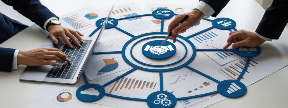 A professional team collaborates during a business meeting, analyzing data charts and utilizing laptops to strategize and discuss key insights for project success. Amity 