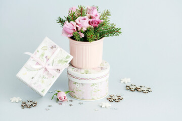 Modern Christmas pink decoration with roses, fir and baubles. Postcard motif.