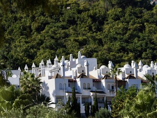 Residential complex of white houses among trees on the Mediterranean coast of Andalusia, Spain