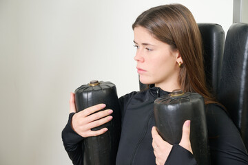 Young woman training hip muscles in gym