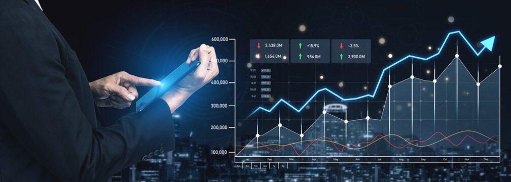 A businessman uses a digital tablet to analyze financial graphs and stock market data against a city skyline, reflecting trends and growth strategies in the modern economy. Scalp