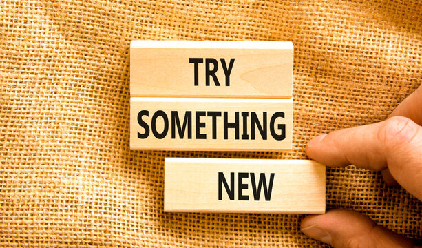 Try something new symbol. Concept words Try something new on beautiful block. Businessman's hand. Beautiful canvas background. Business motivational lifestyle try something new concept. Copy space.
