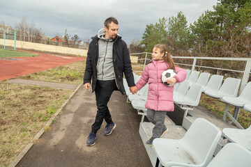 Dad and daughter having nice conversation after football training recreation activity