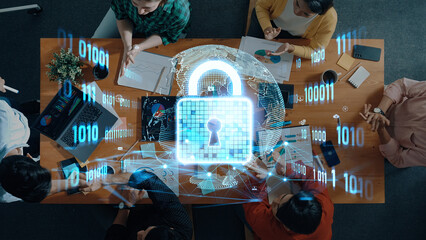 Professionals engage in a collaborative meeting focused on cybersecurity strategies, with a digital lock symbol illustrating data protection themes amidst technology and teamwork. Trope