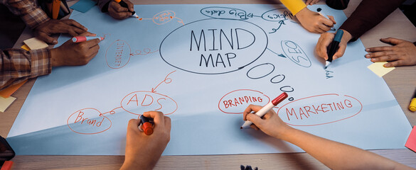 A vibrant workspace featuring a group of hands engaging in a brainstorming session around a large mind map. Colorful sticky notes and markers create an energizing atmosphere for collaboration. SACTR