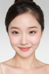 Obraz premium Female Asian Model with Short Hair - Young Beautiful Woman with Hair Bun - Studio Portrait of Asian Beauty for Fashion, Cosmetic, Skincare - Posing on White Background - Smooth Tied Hair