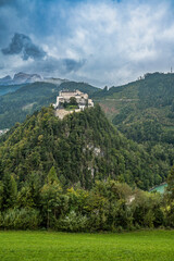 Hohenwerfen Castle on forested hilltop in Austrian Alps
