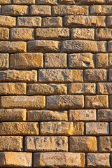 Naklejka premium Medieval Yellow Stone Brick Wall Background in Florence Tuscany Italy