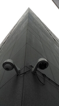 Security cameras on the corner of the tall building