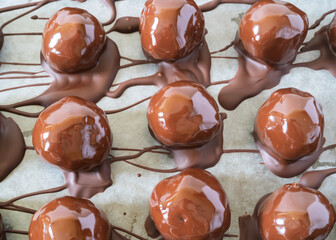 Homemade Christmas chocolate balls on parchment paper.