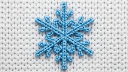 Adorable blue snowflake on cozy white knitted fabric evokes winter's charm, perfect for holiday crafts, seasonal designs, and warm festive greetings