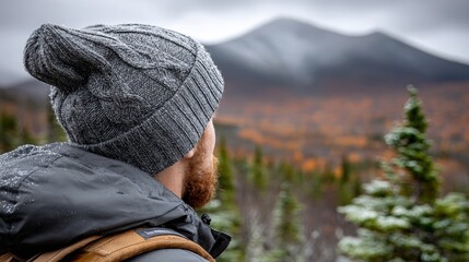 A Backpacker Trekking Through Stunning Winter Wilderness Mountains with Colorful Snow-Covered Slopes