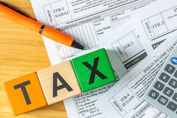 India, income tax return form. Financial and business concept. Indian national colors and the word TAX. itr forms, money, and a calculator. Closeup. Flat lay