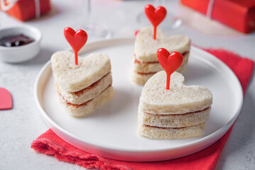 Sandwiches with berries jam in the form of hearts for Valentine's day holidays