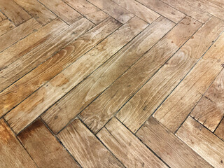 Old dirty, damaged and scratched wooden parquet floor needing restoration