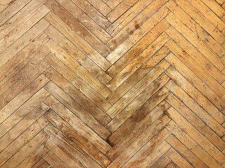 Old dirty, damaged and scratched wooden parquet floor needing restoration