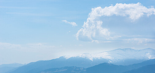 snowy mountain peaks and clouds, winter in the mountains